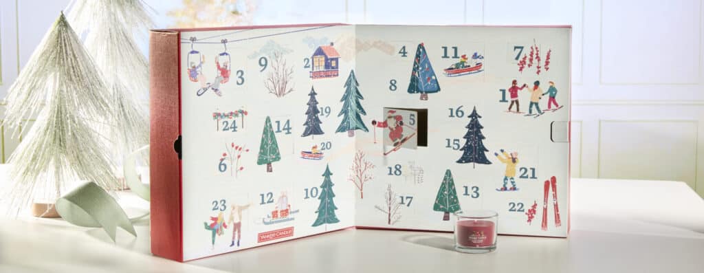 Adventskalender med julmotiv och doftljus, perfekt för nedräkning till jul.